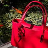 Classy setting next to Koi fish pond of Red Italian handbag showing details of bag. - Don de Dieu Marque